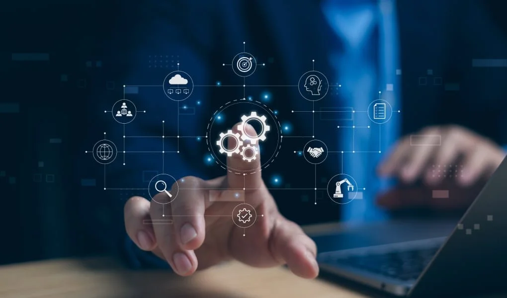 Automatic control system with modern technology for managing business processes Concept. A businessman taps a gear icon showing the operation of robot automation software on computer.