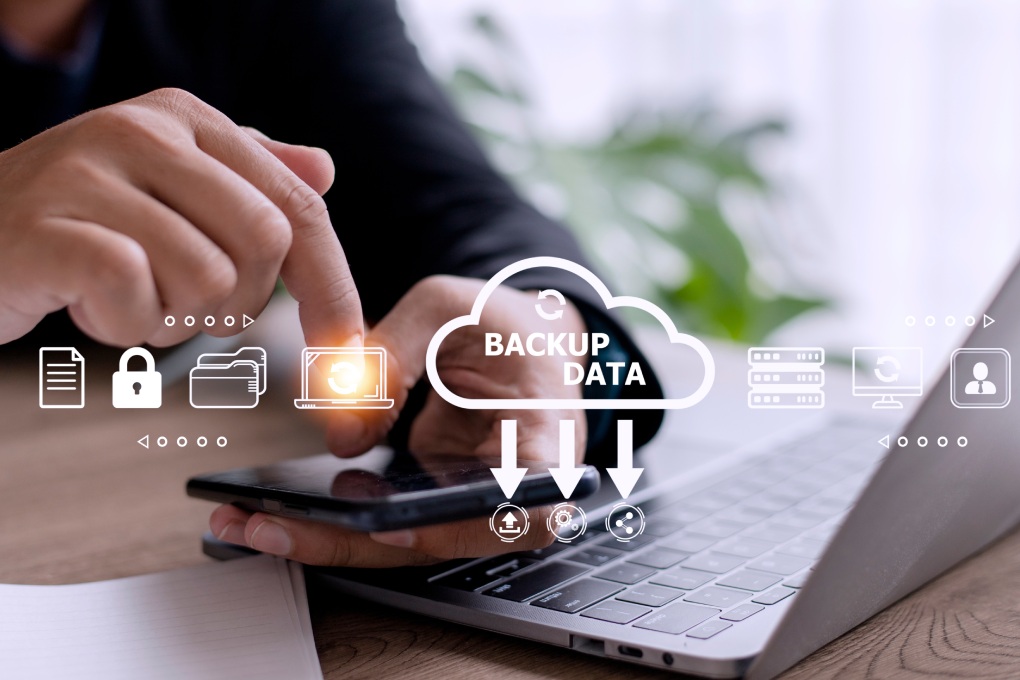 Businessman using a computer to backup storage data Internet technology concept for backup online documentation database and digital file storage system or software,file access, doc sharing.