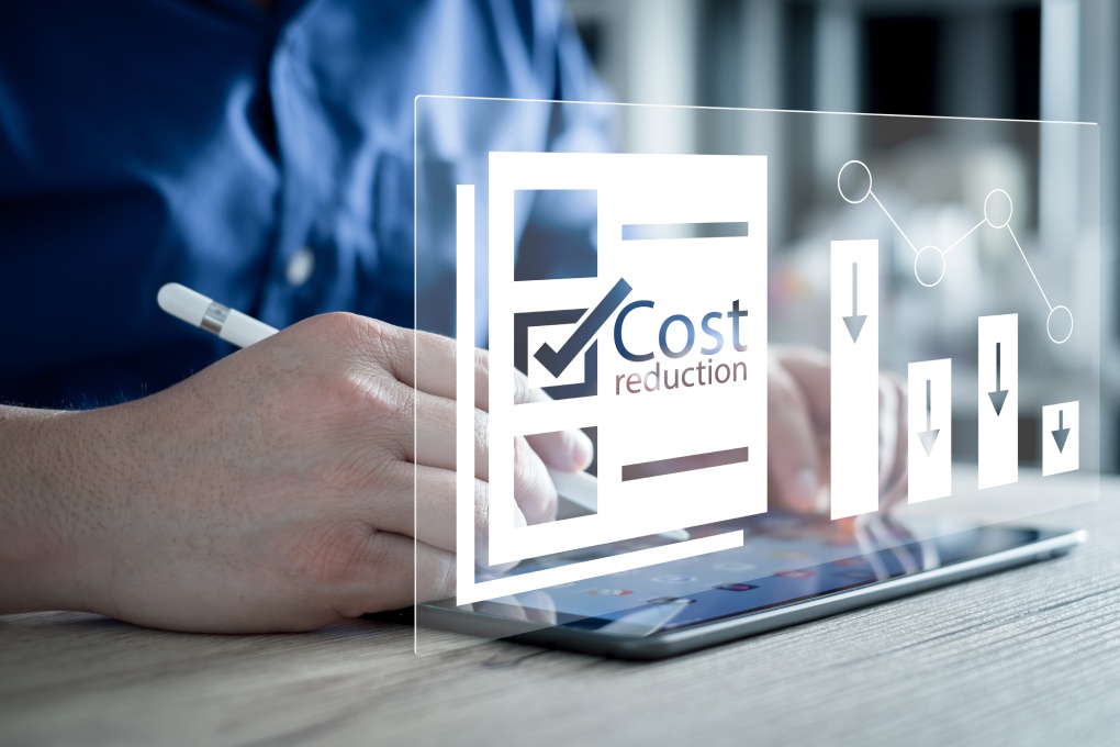 Cost reduction Concept. Businessman with his hand lowers the arrow of the graph. Cost text with a down arrow. budget, Cost Management. cut, lower.