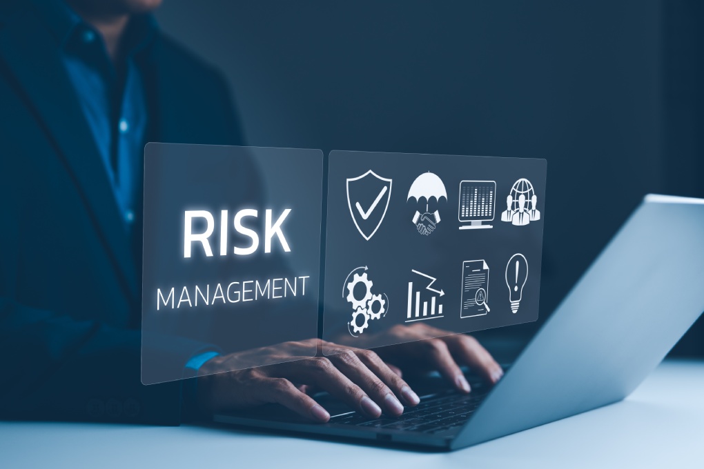 Corporate risk management strategy concept. A businessman is analyzing a virtual risk management interface with critical strategy icons on a laptop screen. Analyze risk assessment, analysis financial,