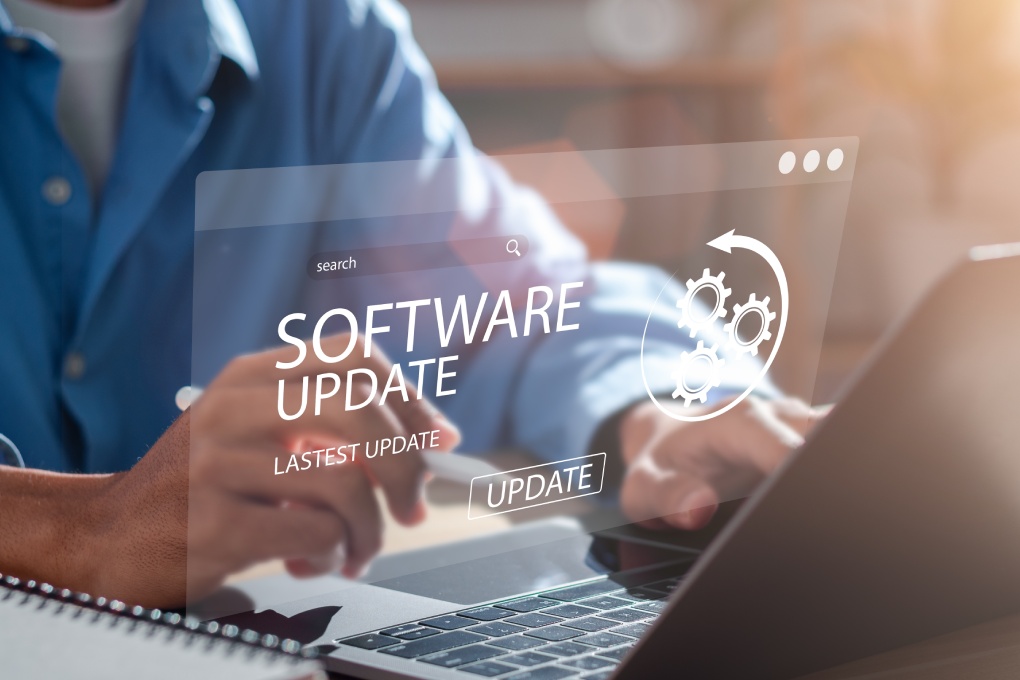 Man working and installing update process. Software updates or operating system upgrades to keep your device up to date with enhanced functionality in new versions and improved security.